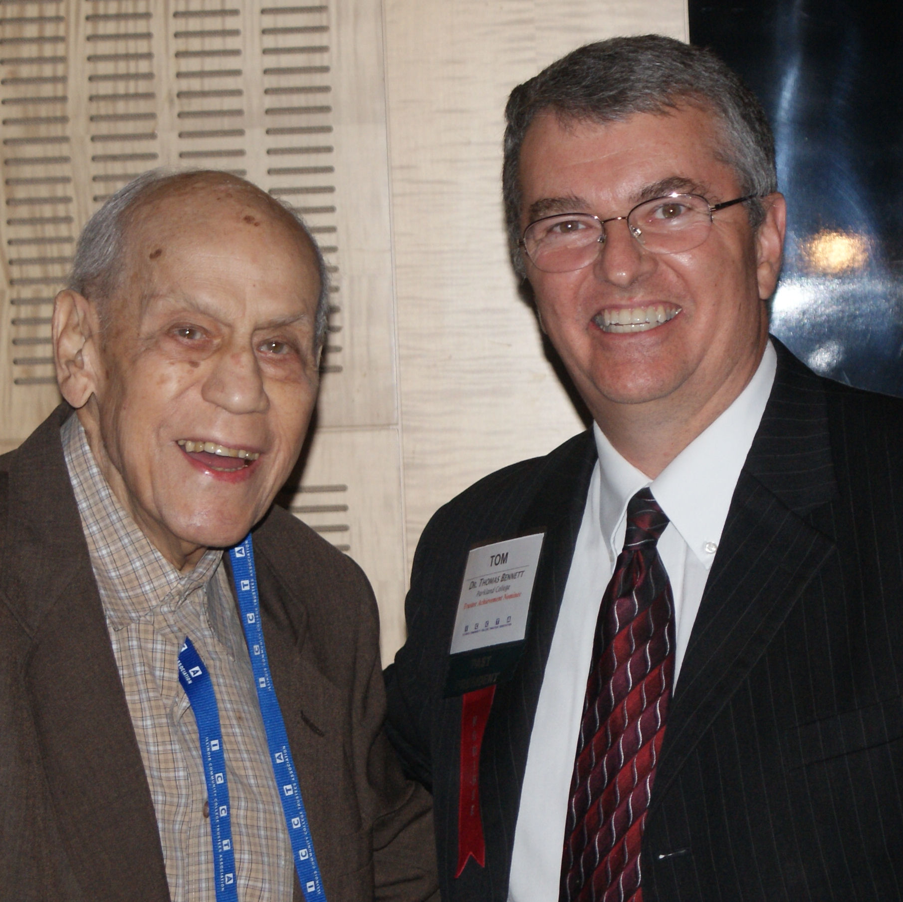 Dr. Tom Bennett receives ICCTA's 2013 Ray Hartstein Trustee Achievement Award from award namesake Ray Hartstein.